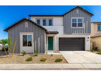 Charming two-story home featuring gray tones, a two-car garage and a welcoming front yard at 9249 E Sector Dr, Mesa, AZ 85212
