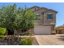 Charming stucco two-story home featuring a manicured lawn, beautiful landscaping, and a two-car garage at 9372 W Louise Dr, Peoria, AZ 85383