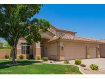 Inviting two-story home with a three-car garage and well-manicured lawn at 986 W Citrus Way, Chandler, AZ 85248