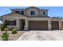 Two-story home featuring a two-car garage, desert landscaping and neutral color palette at 997 E White Wing Dr, Casa Grande, AZ 85122