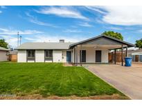 Charming single story home featuring a carport and a well-manicured lawn at 1228 E Fremont Dr, Tempe, AZ 85282
