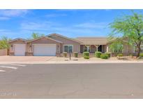 Charming single-story home with a three-car garage and beautifully landscaped front yard at 1336 E Belmont Ave, Phoenix, AZ 85020