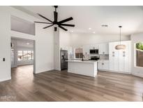 Open floor plan with high ceilings showcasing kitchen, living and dining areas at 15226 S 14Th Dr, Phoenix, AZ 85045