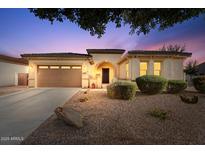 Charming single-story home boasts a well-manicured landscape, a two-car garage, and inviting curb appeal at 19403 E Apricot Ln, Queen Creek, AZ 85142