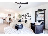 Bright living room featuring a modern ceiling fan, stylish furnishings, and elegant decor at 2511 W Queen Creek Rd # 325, Chandler, AZ 85248