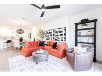 Inviting living room features an orange sectional sofa, stylish decor, and an open-concept design at 2511 W Queen Creek Rd # 325, Chandler, AZ 85248