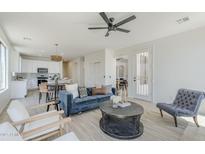 Bright and inviting living room with plush seating, modern ceiling fan, and open-concept design at 2755 N 103Rd Ave, Avondale, AZ 85392