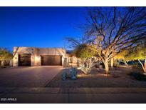 Charming single-story home featuring a three-car garage, desert landscaping, and neutral-colored exterior paint at 31721 N 138Th Pl, Scottsdale, AZ 85262