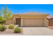 Charming single-story home with desert landscaping, neutral colors, and a two-car garage at 41227 N Rolling Green Way, Anthem, AZ 85086