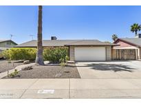 Charming single-story home featuring a well-maintained front yard and two-car garage at 6605 W Altadena Ave, Glendale, AZ 85304