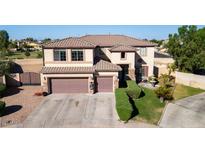 Two-story home with a three-car garage, desert landscaping and well-maintained lawn at 7102 W Pueblo Ave, Phoenix, AZ 85043