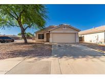 Charming single-story home featuring a two-car garage and low-maintenance desert landscaping at 10956 E Delta Ave, Mesa, AZ 85208