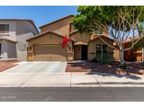 Charming two-story home featuring a well-manicured front yard and a two-car garage at 11836 W Planada Ct, Sun City, AZ 85373