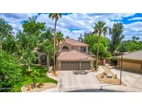 Stunning two-story home featuring a spacious three-car garage and beautifully landscaped front yard at 1571 E Saratoga Ct, Gilbert, AZ 85296