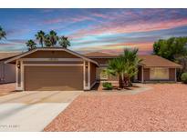 Charming single-story home featuring a well-manicured yard with mature trees, fresh gravel, and a two-car garage at 1630 W Calle Del Norte --, Chandler, AZ 85224
