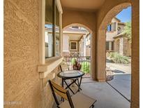 Cozy patio area with a round table and two chairs, perfect for relaxing outdoors at 17802 N 114Th Ln, Surprise, AZ 85378