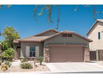 Inviting single-story home featuring desert landscaping, a two-car garage, and a well-maintained front yard at 18198 E El Viejo Desierto --, Gold Canyon, AZ 85118