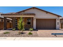 Charming home featuring a brick facade, desert landscaping, and a spacious two-car garage at 19338 S 212Th Pl, Queen Creek, AZ 85142
