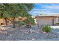 Charming single-story home with low maintenance desert landscaping, rock mulch and a two car garage at 19882 N Crimson Ridge Way, Surprise, AZ 85374
