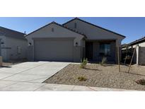 Charming single-story home with a two-car garage, well-maintained landscaping and neutral color palette at 23214 W Miami St, Buckeye, AZ 85326