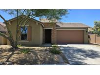 Charming single-story home with a brick facade, desert landscaping, and a two-car garage at 23853 W Hammond Ln, Buckeye, AZ 85326