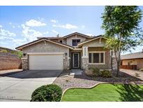 Inviting two-story home with manicured landscaping and a spacious two car garage at 31133 N 132Nd Ln, Peoria, AZ 85383