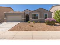 Charming single-story home with a well-manicured front yard and a two-car garage at 4108 N 304Th Ln, Buckeye, AZ 85396