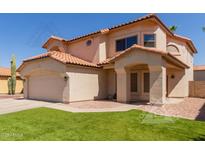 Charming two-story home with a well-manicured lawn and a two car garage at 4514 E Verbena Dr, Phoenix, AZ 85044