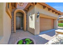 Inviting home entrance with a brick-paved walkway and charming arched doorway at 7261 E Norland St, Mesa, AZ 85207