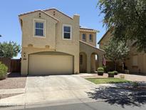Charming two-story home with a stucco exterior, attached garage, and inviting curb appeal at 7321 S 48Th Dr, Laveen, AZ 85339