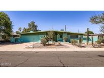 Charming single-story home with unique desert landscaping and vibrant color scheme at 736 E Loyola Dr, Tempe, AZ 85282