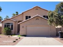 Charming single-Gathering home featuring a two-car garage, well-kept landscaping, and desert-style front yard at 8478 W Grovers Ave, Peoria, AZ 85382