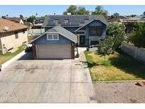 Charming blue two-story home featuring solar panels, a spacious driveway, and well-maintained landscaping at 8908 W Sheridan St, Phoenix, AZ 85037