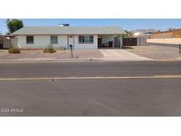 Charming single-story home with a driveway and simple, low-maintenance desert landscaping at 9726 E Quarterline Rd, Mesa, AZ 85207
