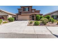Two-story home featuring a tile roof, large garage and desert landscaping at 10827 W Bronco Trl, Peoria, AZ 85383