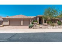 Beautiful single-story home featuring a tile roof, manicured landscaping, and a spacious three-car garage at 12120 E Cortez Dr, Scottsdale, AZ 85259
