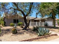 Charming home featuring xeriscape landscaping, a welcoming patio, and an attached two-car garage at 1502 E Minton Dr, Tempe, AZ 85282