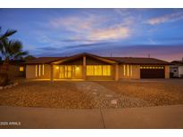 Charming single story brick home boasting meticulously maintained desert landscaping and a two car garage at 211 N 7Th St, Avondale, AZ 85323