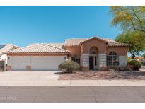 Charming single-story home with a well-maintained front yard and three-car garage, offering great curb appeal at 3550 E Topeka Dr, Phoenix, AZ 85050