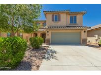 Charming two-story home with a well-maintained front yard and a two-car garage at 38191 W Merced St, Maricopa, AZ 85138