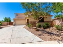 Two-story stucco home with stone accents, desert landscaping, and a two-car garage at 42616 W Avella Dr, Maricopa, AZ 85138