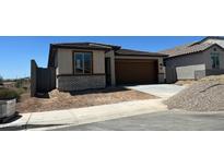 Charming single-story home featuring a brick-accented facade and a spacious two-car garage at 5650 S 253Rd Ave, Buckeye, AZ 85326