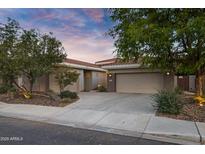 Charming single-story home with a well-manicured yard and a spacious two-car garage at dusk at 645 W Longhorn Dr, Chandler, AZ 85286