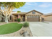 Charming single-story home with a well-maintained front yard and a two-car garage at 7027 W Blackhawk Dr, Glendale, AZ 85308