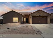 Charming single-story home with desert landscaping and a two-car garage, perfect for comfortable living at 7736 W Tumblewood Dr, Peoria, AZ 85382
