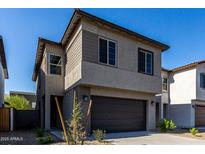 Two story home featuring a two-car garage, low maintenance landscaping, and a stucco exterior at 9366 E Sequence Ave, Mesa, AZ 85212