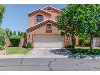 Two-story home featuring a front-facing garage and well-maintained landscaping at 111 N Soho Pl, Chandler, AZ 85225