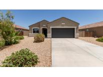 Charming single-story home featuring low-maintenance desert landscaping and a spacious two-car garage at 11303 E Sunflower Ct, Florence, AZ 85132