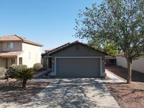 Charming single-story home with a well-maintained front yard, mature tree, and inviting curb appeal at 11936 W Charter Oak Rd, El Mirage, AZ 85335