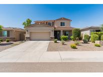 Charming two-story home with a well-manicured lawn and a two-car garage on a sunny day at 12236 W Country Club Ct, Sun City, AZ 85373